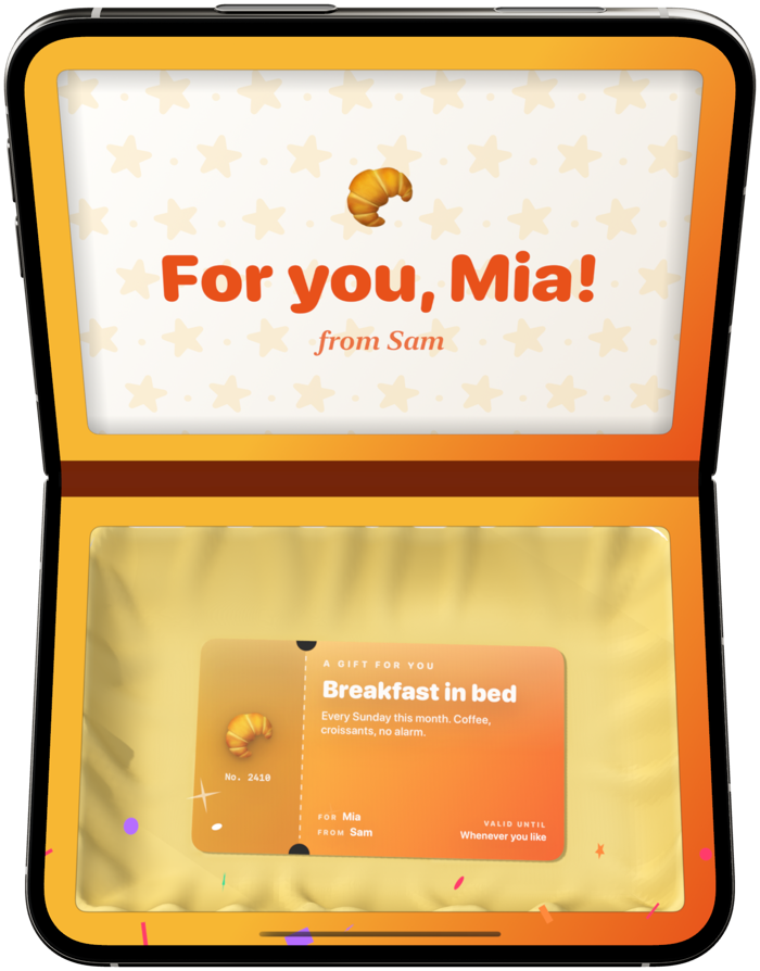 An orange gift box open: “For you, Mia!” in the lid and a voucher for breakfast in bed in the tissue